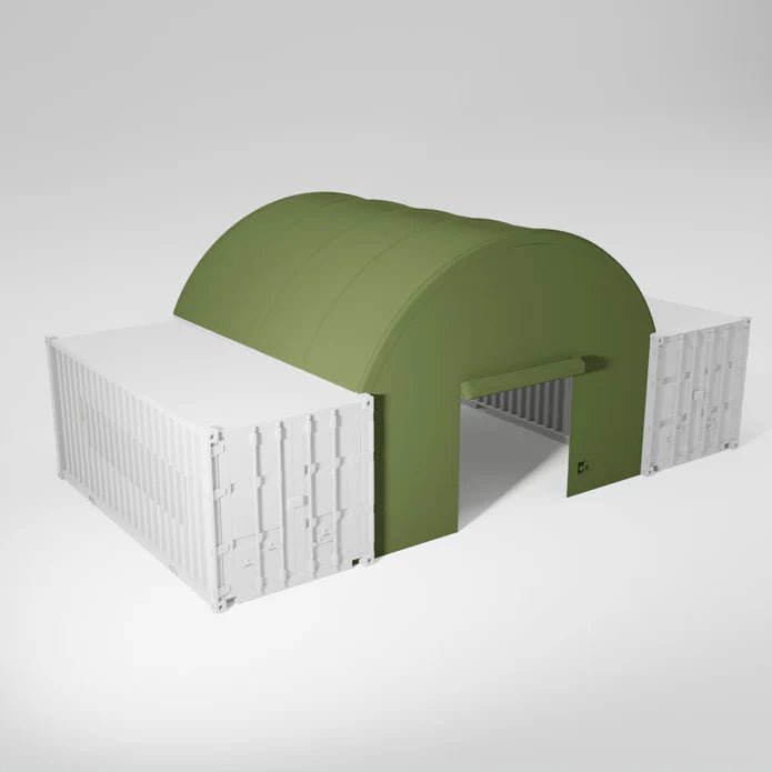 An olive green, semi-circular tent connects two white storage containers.
