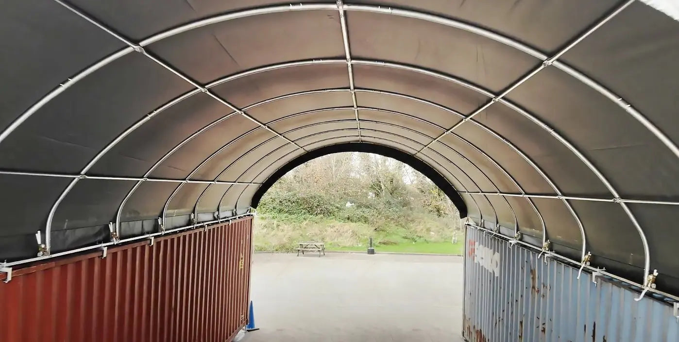 Tunnel shelter between shipping containers.